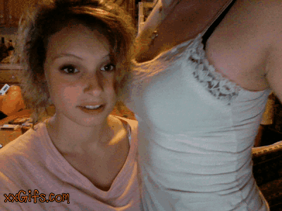 lady having her teeth in her lesbomates titty in front of a cam
