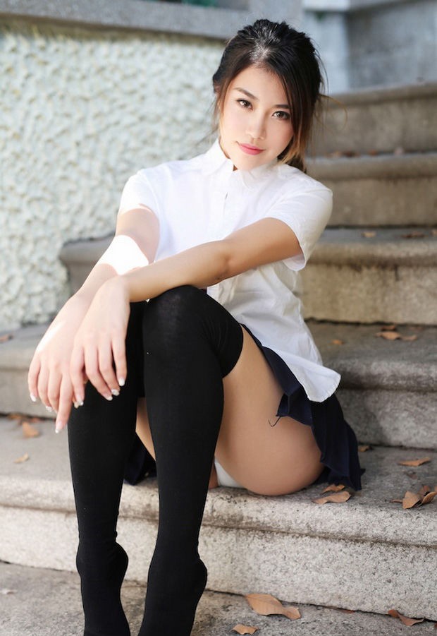 nice chinese sitting on the steps and providing us a peek at her undies